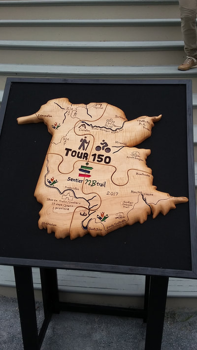 The wooden map of New Brunswick cut into four puzzle pieces, still lives in Fredericton to remind us of every step we made in this great journey!